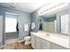 Bathroom featuring a white vanity, large mirror, and shower with closet in the background at 17060 Kingsbridge Blvd, Westfield, IN 46074