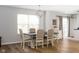 Bright dining room with a modern chandelier and wood-style floors at 17060 Kingsbridge Blvd, Westfield, IN 46074