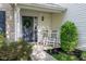 Charming front entrance with a wreath on the door and rocking chairs at 17060 Kingsbridge Blvd, Westfield, IN 46074