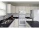 Spacious kitchen features white appliances, white cabinets, and black countertops at 17060 Kingsbridge Blvd, Westfield, IN 46074