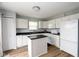 White kitchen with island features white appliances and wood floor at 17060 Kingsbridge Blvd, Westfield, IN 46074
