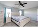 This primary bedroom has a ceiling fan, carpet, and is well-lit with windows and lamps at 17060 Kingsbridge Blvd, Westfield, IN 46074