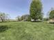 Expansive backyard with lush green grass and mature trees, offering plenty of space for outdoor activities at 1858 Jenny Dr, Martinsville, IN 46151