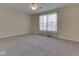 Spacious bedroom with soft carpet, ceiling fan, and large window for natural light and sheer, elegant curtains at 1858 Jenny Dr, Martinsville, IN 46151