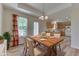 Bright dining room featuring a wooden table set for four and a chandelier above at 1858 Jenny Dr, Martinsville, IN 46151