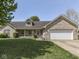 Inviting single-story home with a well-manicured lawn, brick accents, and an attached two-car garage at 1858 Jenny Dr, Martinsville, IN 46151