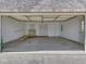 Spacious garage with ample storage, including a ramp, interior and exterior door access, and overhead lighting at 1858 Jenny Dr, Martinsville, IN 46151