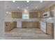 Bright kitchen featuring wooden cabinets, white appliances, and a light-colored floor at 1858 Jenny Dr, Martinsville, IN 46151