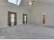 Spacious main bedroom featuring vaulted ceilings, large windows, neutral carpet, and ample natural light at 1858 Jenny Dr, Martinsville, IN 46151