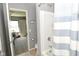 Clean bathroom with combination tub and shower, and an open doorway to the bedroom at 2075 Longford Ln, Avon, IN 46123