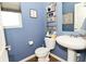 The half bathroom features a stylish pedestal sink and modern decor, optimizing space and design at 2075 Longford Ln, Avon, IN 46123