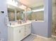 This bathroom boasts double sinks with a large mirror, tiled walls and floor, and a shower at 2075 Longford Ln, Avon, IN 46123