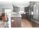Modern kitchen with granite countertops, stainless steel appliances, and dark wood cabinetry at 2075 Longford Ln, Avon, IN 46123