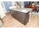 Kitchen island with granite countertop and dark wood cabinetry, adding style and functionality at 2075 Longford Ln, Avon, IN 46123