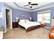 This spacious main bedroom features a tray ceiling, a ceiling fan, and a view to the outdoors at 2075 Longford Ln, Avon, IN 46123