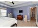 A section of this main bedroom includes a TV, dresser, chair, and a view to the outdoors at 2075 Longford Ln, Avon, IN 46123