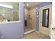 This tiled shower area has a small window and a frosted glass partition allowing light and privacy at 2075 Longford Ln, Avon, IN 46123