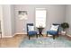 Bright sitting area with comfortable chairs and a window, perfect for relaxation and reading at 2075 Longford Ln, Avon, IN 46123
