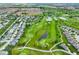 Wide aerial shot displaying homes alongside a golf course, ponds, and the surrounding green landscape at 2250 Somerset Dr, Franklin, IN 46131