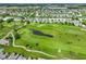 Wide aerial view showing a neighborhood, golf course, and pond, with residential area in background at 2250 Somerset Dr, Franklin, IN 46131