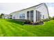 Spacious backyard featuring a screened porch, green lawn, and manicured flower beds adding to the home's appeal at 2250 Somerset Dr, Franklin, IN 46131