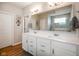 Bright bathroom features a double sink vanity with white cabinets, quartz counters and an enclosed tiled shower at 2250 Somerset Dr, Franklin, IN 46131