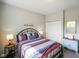 Cozy bedroom with a decorative metal frame bed, colorful bedding and a blue dresser at 2250 Somerset Dr, Franklin, IN 46131