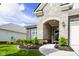 Home entrance with stone accents, lush flower beds, and a well-maintained walkway at 2250 Somerset Dr, Franklin, IN 46131