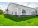Exterior view of a home with a well-kept lawn, brick foundation, and visible screened porch area at 2250 Somerset Dr, Franklin, IN 46131