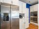 Kitchen view with stainless refrigerator, white cabinets, stone backsplash and hardwood floors at 2250 Somerset Dr, Franklin, IN 46131