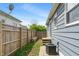 Cozy backyard featuring a wooden privacy fence, bench, and well-maintained air conditioning unit at 2263 N Rural St, Indianapolis, IN 46218