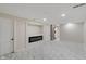 Renovated basement with marble floors, modern fireplace, and access to stairs at 2263 N Rural St, Indianapolis, IN 46218