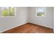Cozy bedroom featuring hardwood floors and two windows letting in natural light at 2263 N Rural St, Indianapolis, IN 46218