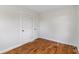 Bright bedroom with hardwood floors, white walls and trim, and two closet doors at 2263 N Rural St, Indianapolis, IN 46218