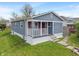 Charming blue home with front porch and landscaped yard, showcasing classic suburban curb appeal at 2263 N Rural St, Indianapolis, IN 46218