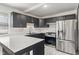 Modern kitchen featuring stainless steel appliances, white marble countertops, and sleek black cabinets at 2263 N Rural St, Indianapolis, IN 46218