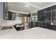 Modern kitchen featuring stainless steel appliances, sleek black cabinets, and marble countertops and backsplash at 2263 N Rural St, Indianapolis, IN 46218