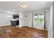 Open-concept living area with wood floors and ample light with black kitchen at 2263 N Rural St, Indianapolis, IN 46218