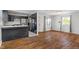 Open living space showcasing the renovated kitchen and hardwood floors throughout at 2263 N Rural St, Indianapolis, IN 46218