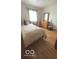 The secondary bedroom features natural light, hardwood floors, and closet at 2402 S Rybolt Ave, Indianapolis, IN 46241
