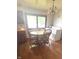 Kitchen area with wood table, chairs, large window, and washer and dryer hookups at 2402 S Rybolt Ave, Indianapolis, IN 46241