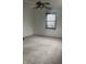 View of the bedroom with a fan and carpet, featuring a window for natural light at 2425 S Lyons Ave, Indianapolis, IN 46241