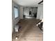 Open living room with window, view of doorway and stairs at 2425 S Lyons Ave, Indianapolis, IN 46241