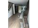 Spacious living room with hardwood floors, a brick fireplace and view to the rear of the home at 2425 S Lyons Ave, Indianapolis, IN 46241