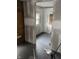 View of the interior living room with bare walls and black flooring during home renovation at 2425 S Lyons Ave, Indianapolis, IN 46241