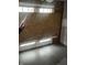 View of the interior living room with boarded up doors and damaged walls during home renovation at 2425 S Lyons Ave, Indianapolis, IN 46241