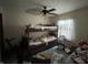 Bedroom featuring bunkbeds, ceiling fan, and natural light from the window at 2517 Baur Dr, Indianapolis, IN 46220