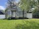 Modest house exterior features a weathered facade, small porch, and overgrown front yard at 2517 Baur Dr, Indianapolis, IN 46220