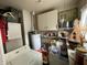 Laundry area with basic appliances, storage, and general disarray and items on the floor at 2517 Baur Dr, Indianapolis, IN 46220