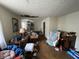 Overcluttered living room with damaged ceiling, dated furniture, and poor condition at 2517 Baur Dr, Indianapolis, IN 46220